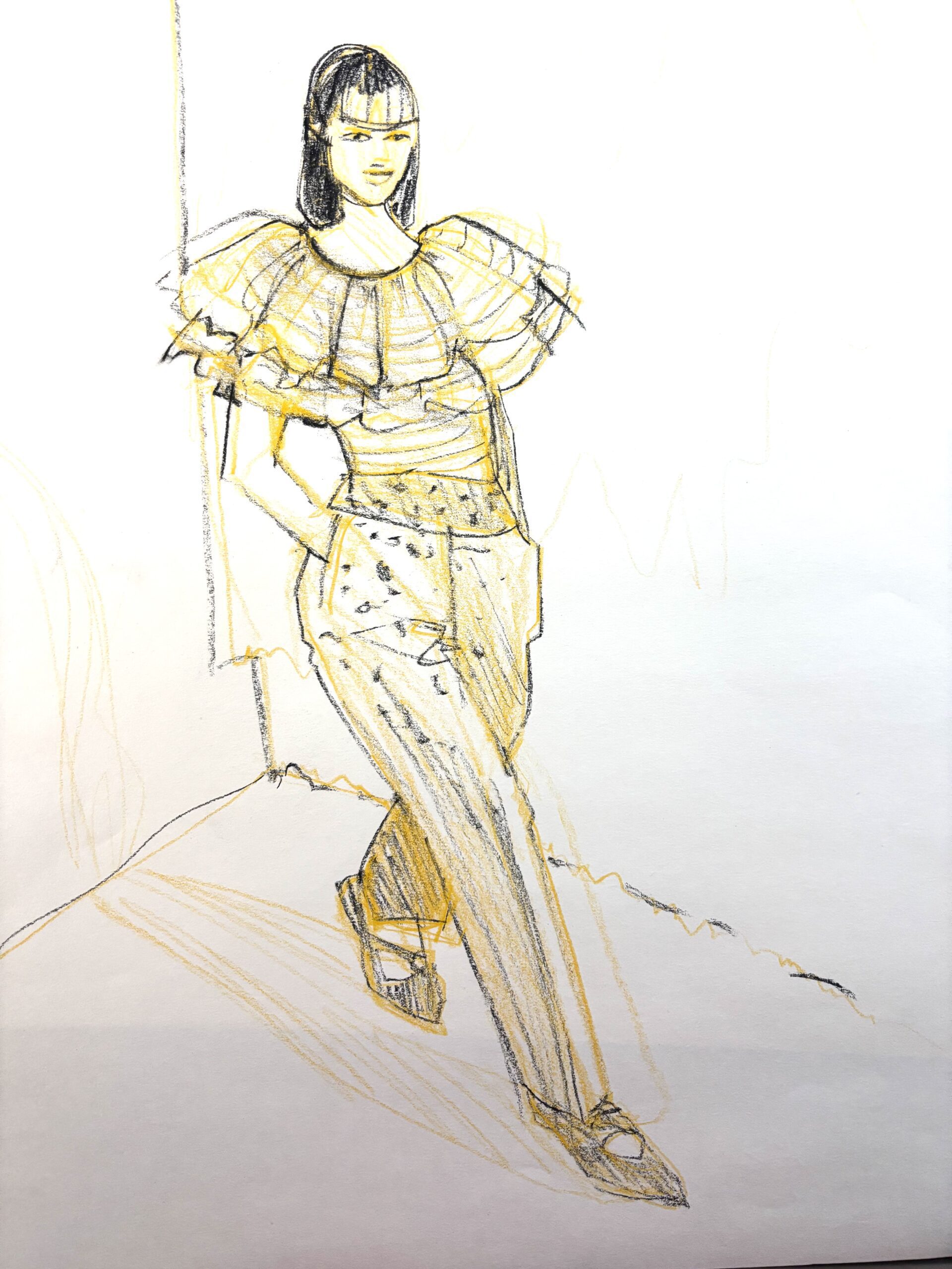 Sketching ruffled, striped top and printed pattern trousers with using black charcoal pencil over an underlayer sketch of yellow ochre colored pencil by Laura Volpintesta